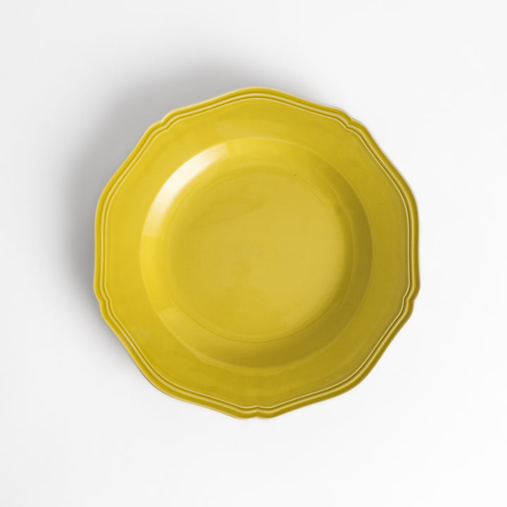 Pretty yellow dinner plate with a delicate scalloped edge, ideal for showcasing your culinary creations.