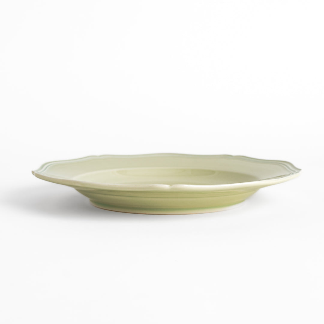 Pretty green dinner plate with a delicate scalloped edge, ideal for showcasing your culinary creations.