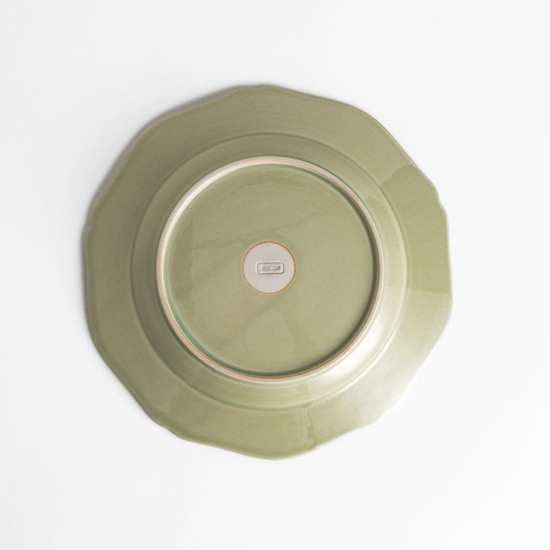 Pretty green dinner plate with a delicate scalloped edge, ideal for showcasing your culinary creations.