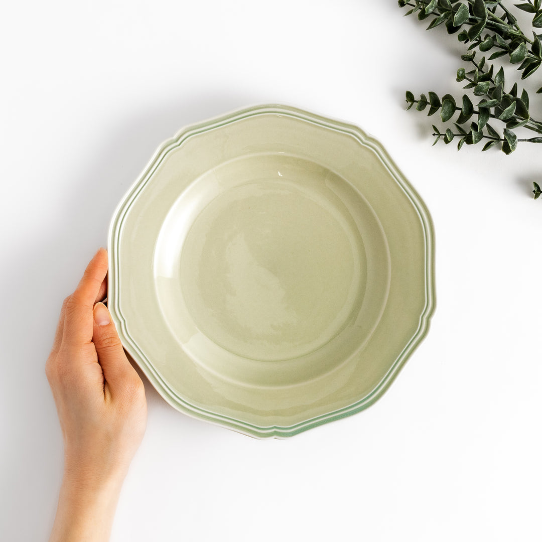 Pretty green dinner plate with a delicate scalloped edge, ideal for showcasing your culinary creations.