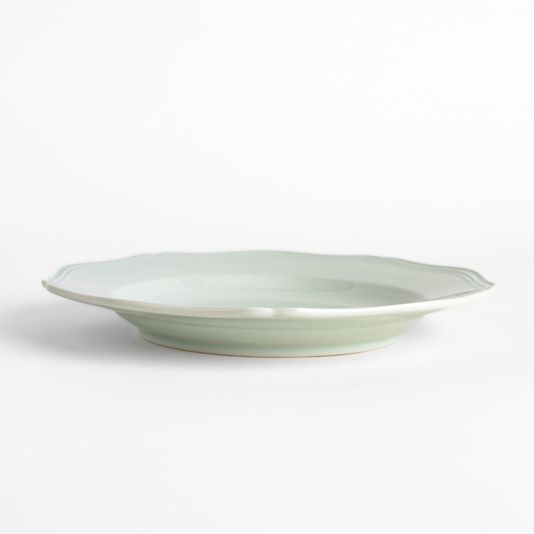 Pretty white dinner plate with a delicate scalloped edge, ideal for showcasing your culinary creations.