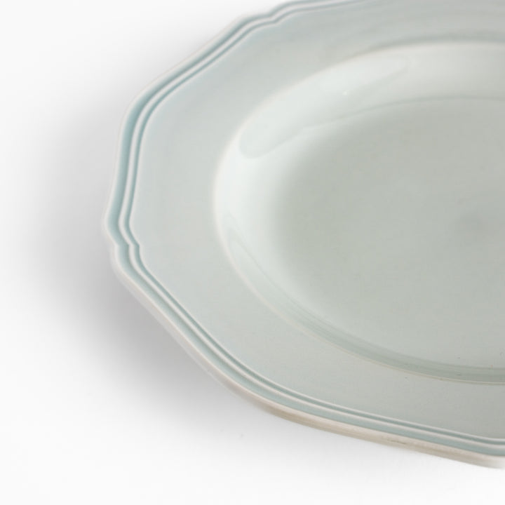 Pretty white dinner plate with a delicate scalloped edge, ideal for showcasing your culinary creations.