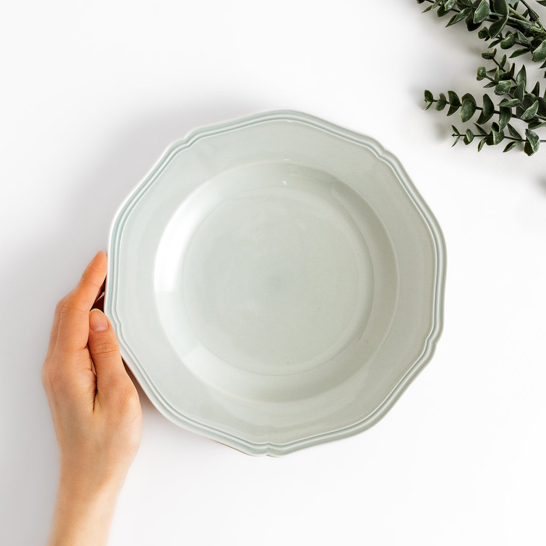 Pretty white dinner plate with a delicate scalloped edge, ideal for showcasing your culinary creations.