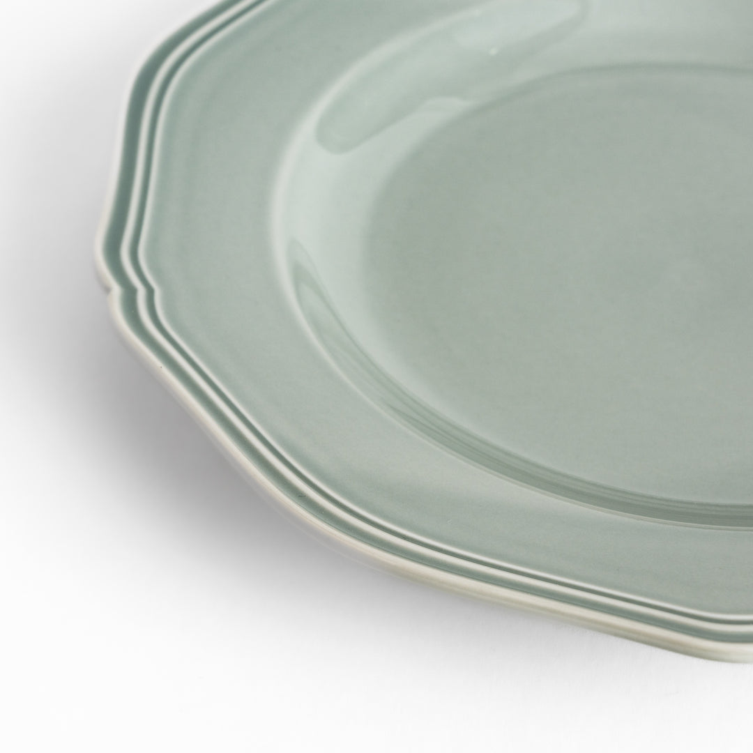 Pretty gray dinner plate with a delicate scalloped edge, ideal for showcasing your culinary creations.