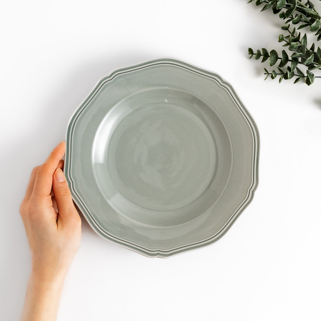 Pretty gray dinner plate with a delicate scalloped edge, ideal for showcasing your culinary creations.