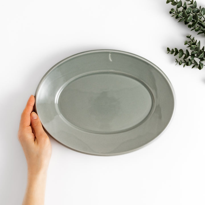 Durable and elegant gray ceramic dinner plate, offering a modern and sophisticated touch to your dining.