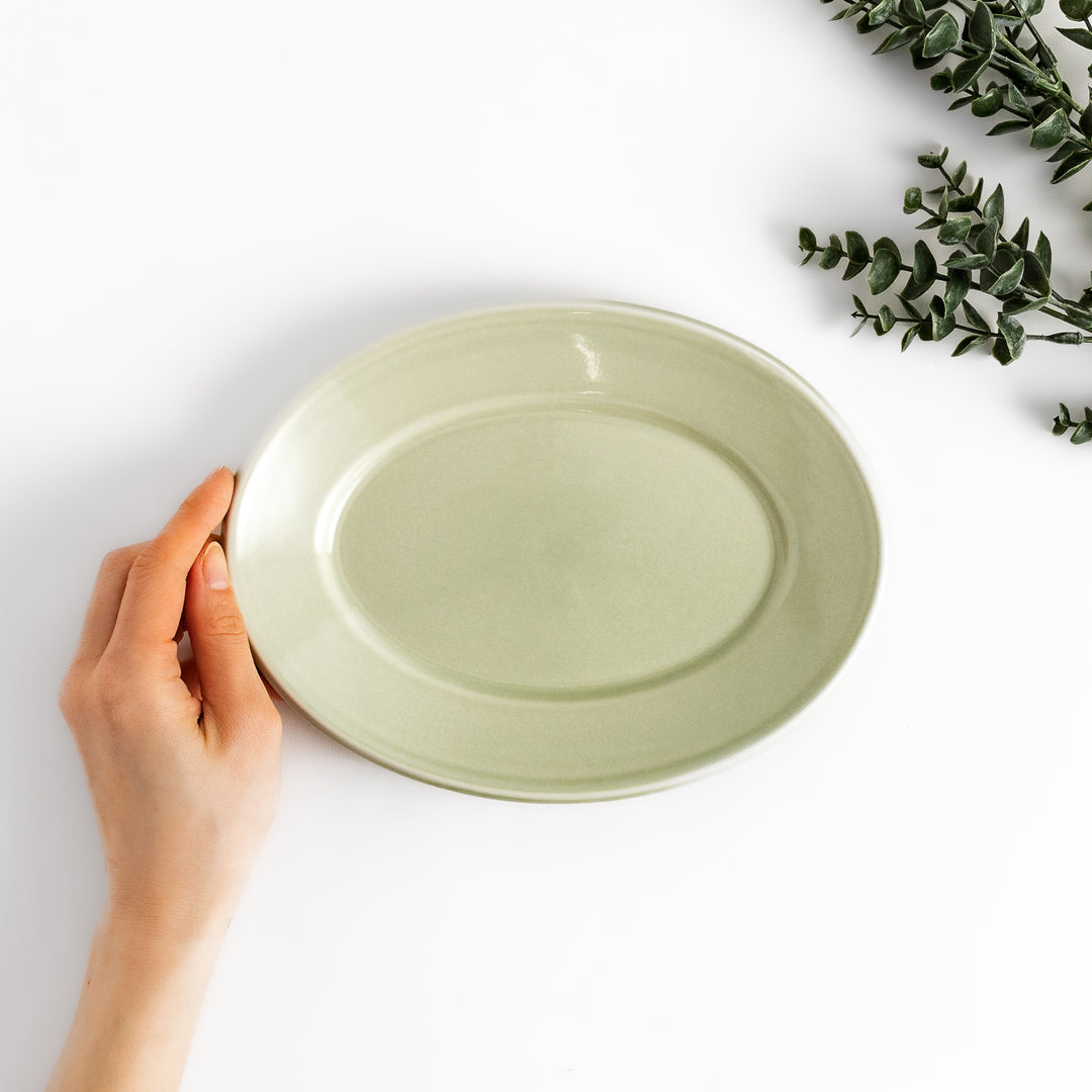 Durable and elegant green ceramic salade plate, bringing a fresh touch to your table setting.