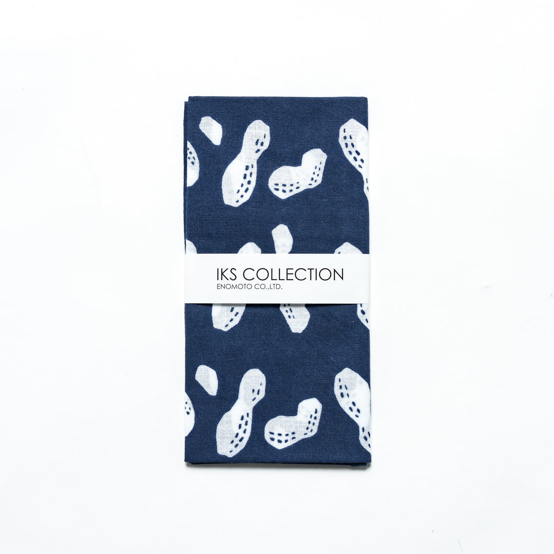 Navy hand towel with white peanut designs, folded with a branded sleeve.