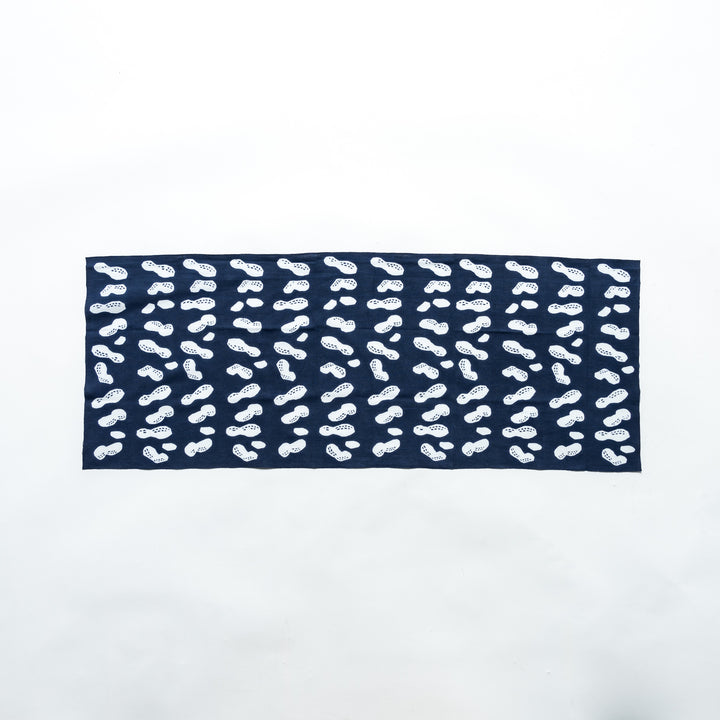 Navy hand towel featuring white peanut motifs, fully spread to display its design.