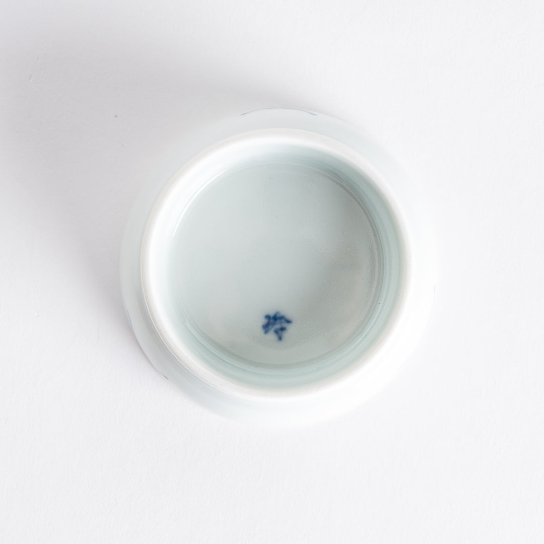 White raised sauce dish featuring a hand-painted blue peony flower.