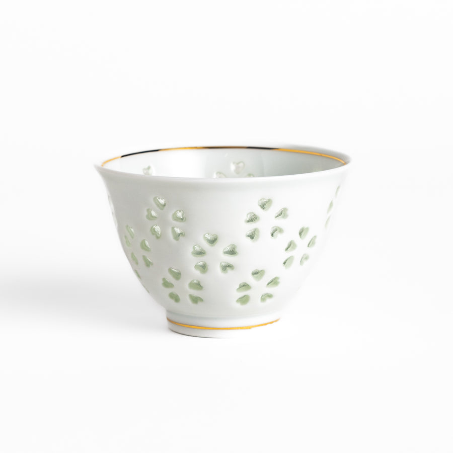 Delicate white teacup with a unique cut-out heart design, perfect for adding a touch of romance to your tea time.