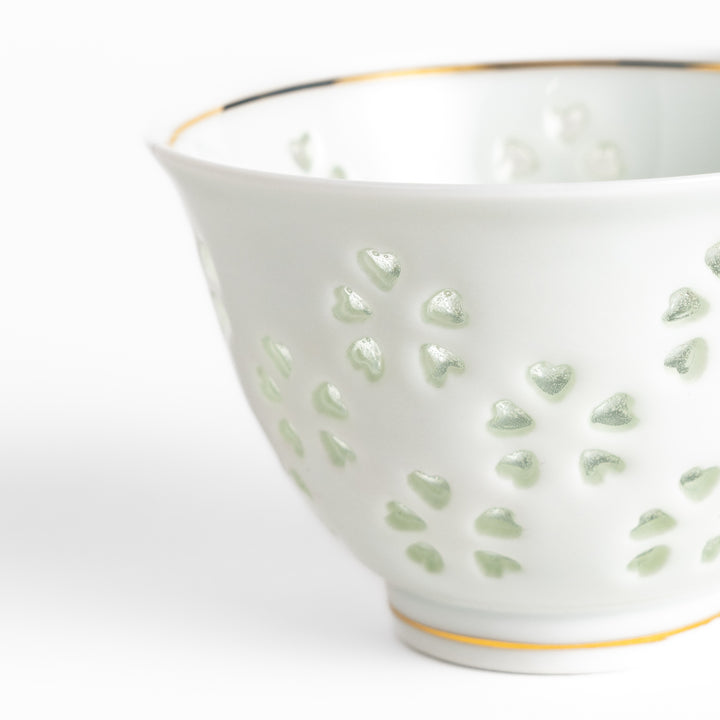 Delicate white teacup with a unique cut-out heart design, perfect for adding a touch of romance to your tea time.