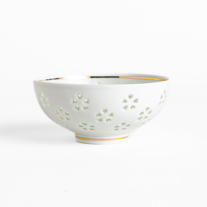 Elegant ceramic rice bowl with a delicate cut-out floral design, perfect for adding a touch of elegance to any meal.