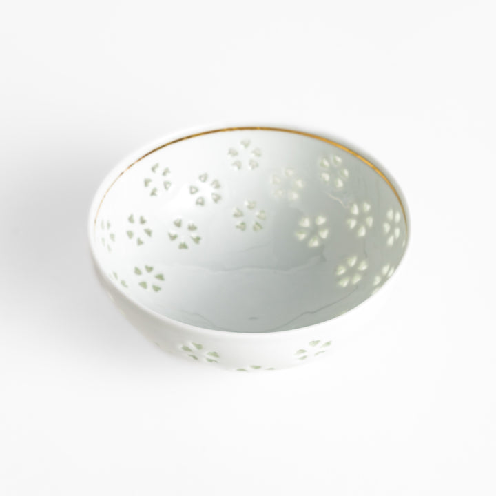 Elegant ceramic rice bowl with a delicate cut-out floral design, perfect for adding a touch of elegance to any meal.