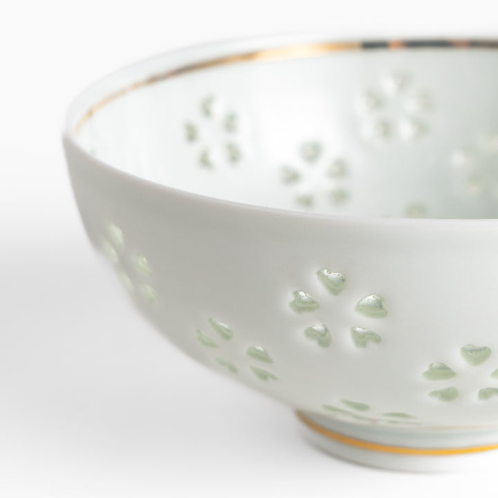 Elegant ceramic rice bowl with a delicate cut-out floral design, perfect for adding a touch of elegance to any meal.