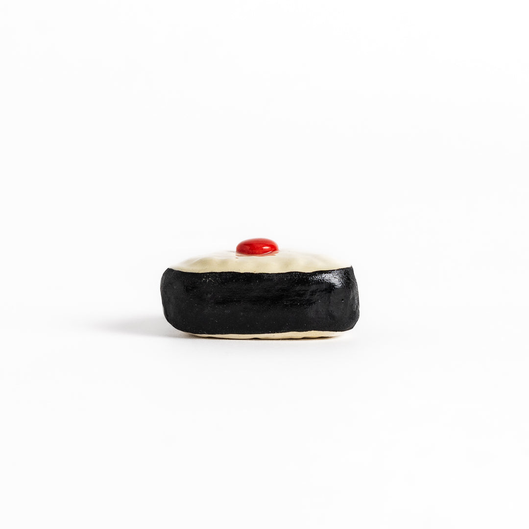 Pickled Plum Onigiri Chopstick Rest featuring a triangular rice ball design with a red plum detail and black seaweed wrap for a playful touch.