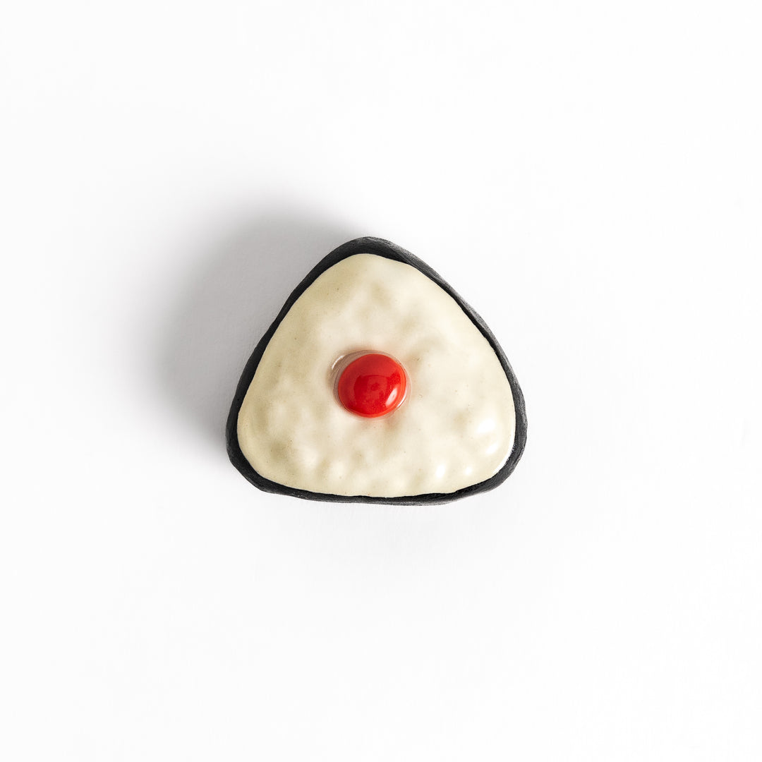 Pickled Plum Onigiri Chopstick Rest featuring a triangular rice ball design with a red plum detail and black seaweed wrap for a playful touch.