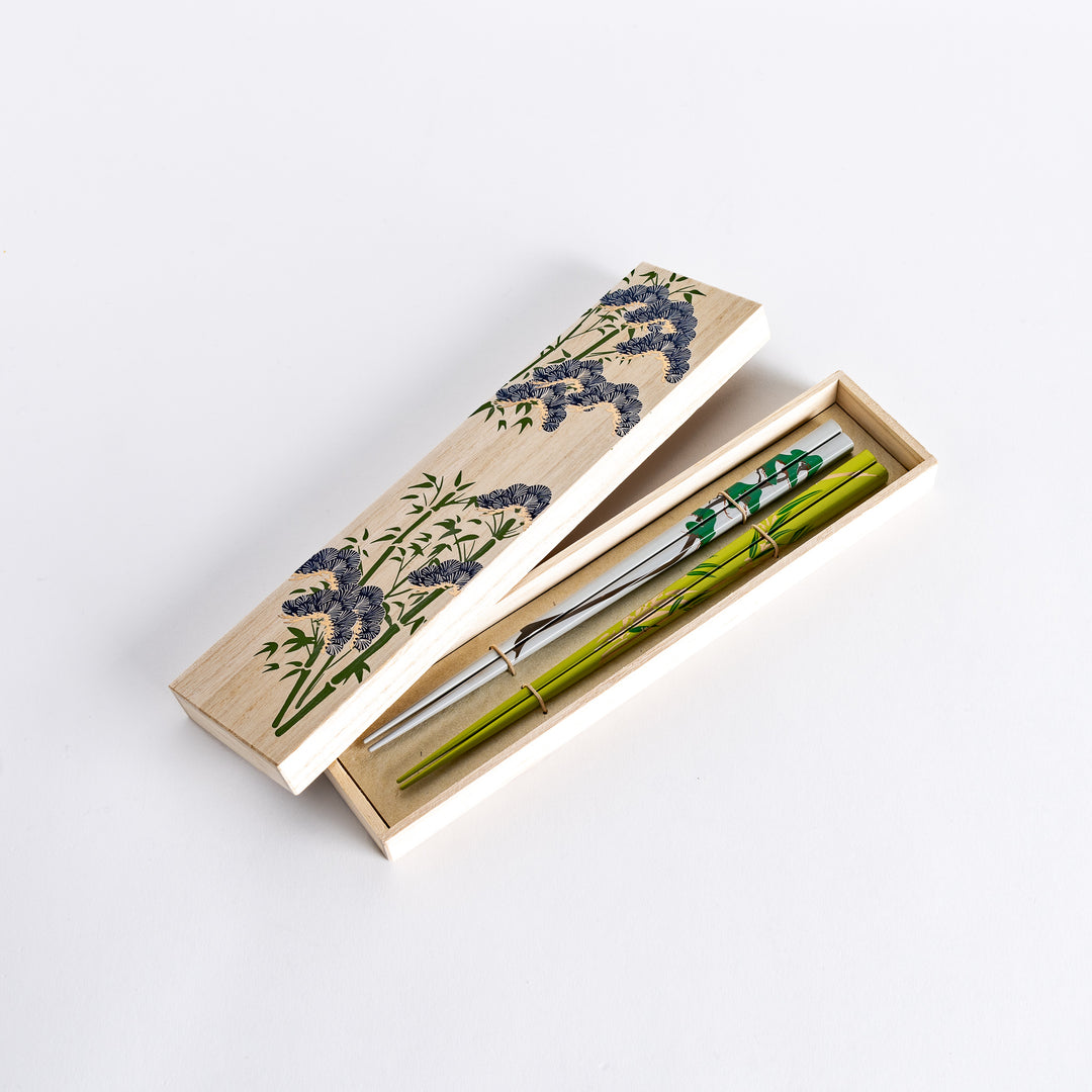 Chopsticks set placed in a beautiful wooden box with an intricately patterned lid, offering an elegant and traditional presentation.