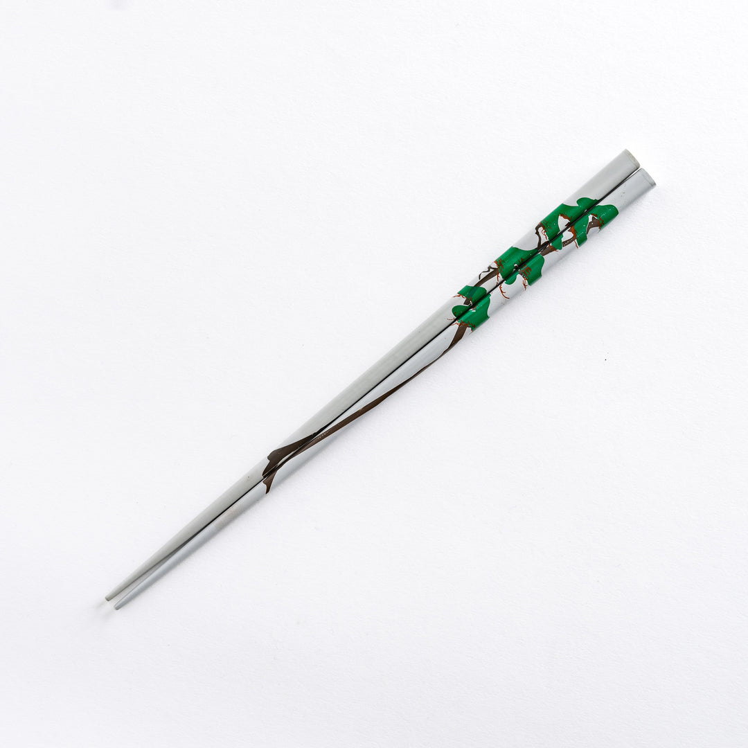 A single chopstick with a pine tree pattern in gray, showcasing the overall design.