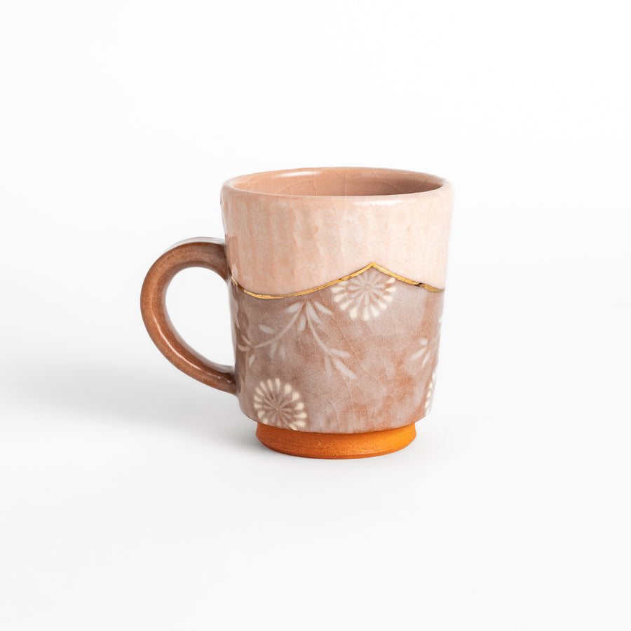 Elegant pink floral mug with a delicate design and gold detailing on the rim, perfect for enjoying hot beverages in style.