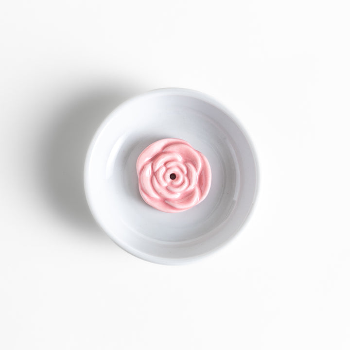 White ceramic incense holder featuring a delicate pink rose-shaped holder, adding an elegant floral touch to incense rituals while enhancing any serene or decorative space.