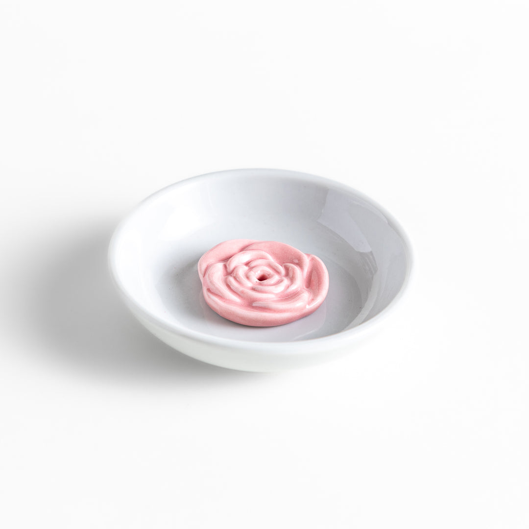 White ceramic incense holder featuring a delicate pink rose-shaped holder, adding an elegant floral touch to incense rituals while enhancing any serene or decorative space.