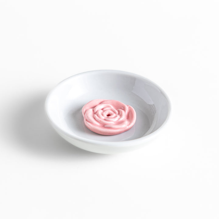 White ceramic incense holder featuring a delicate pink rose-shaped holder, adding an elegant floral touch to incense rituals while enhancing any serene or decorative space.