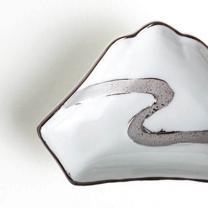 Mt. Fuji-shaped plate with a silver wave pattern on a white background.