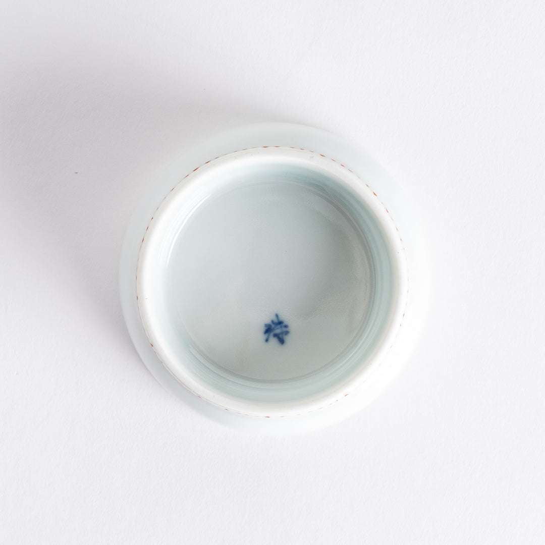 White raised sauce dish featuring a hand-painted blue peony flower.