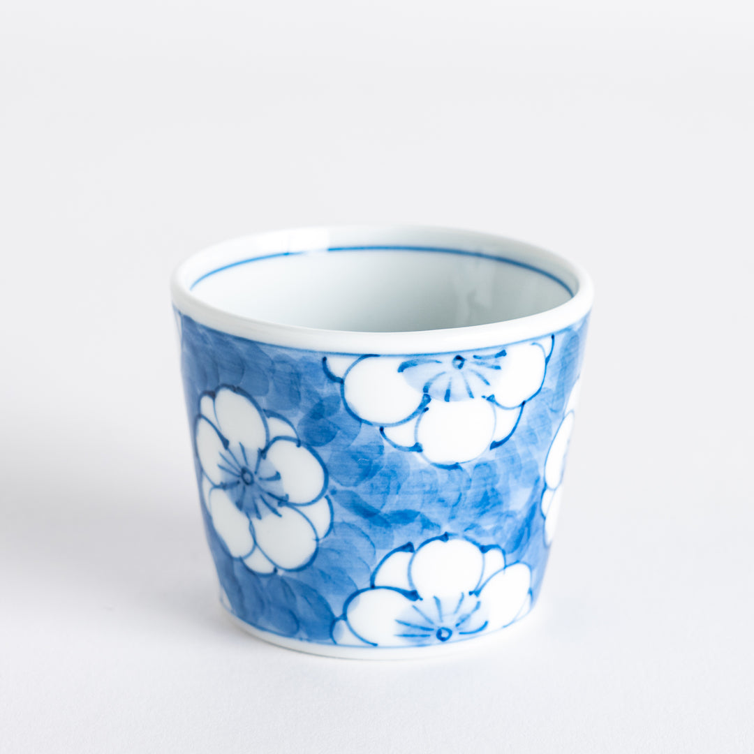 A small porcelain condiment bowl adorned with a blue floral pattern and soft brush strokes.