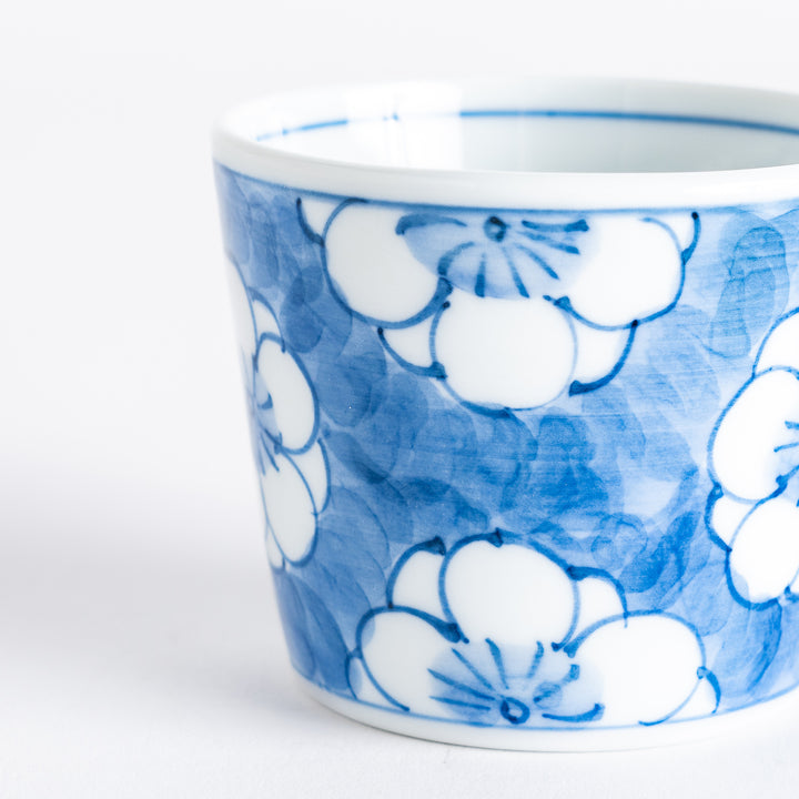 A small porcelain condiment bowl adorned with a blue floral pattern and soft brush strokes.