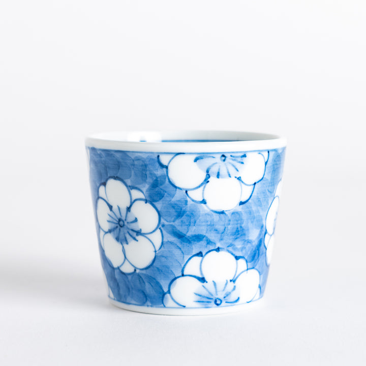 A small porcelain condiment bowl adorned with a blue floral pattern and soft brush strokes.