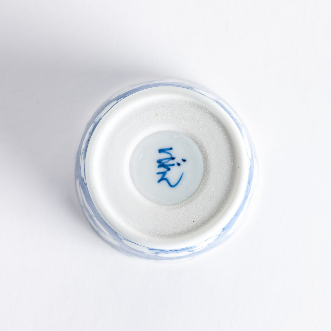 A small porcelain condiment bowl adorned with a blue floral pattern and soft brush strokes.