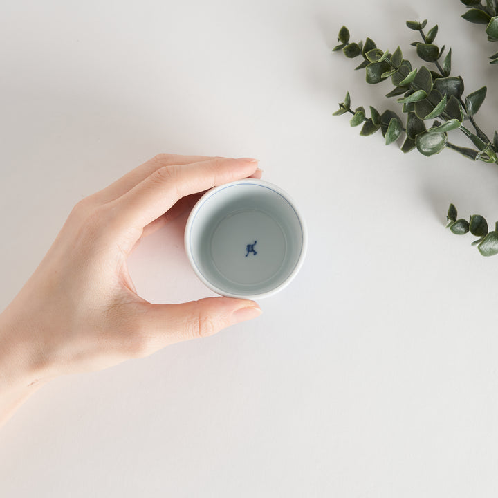 A small porcelain condiment bowl adorned with a blue floral pattern and soft brush strokes.