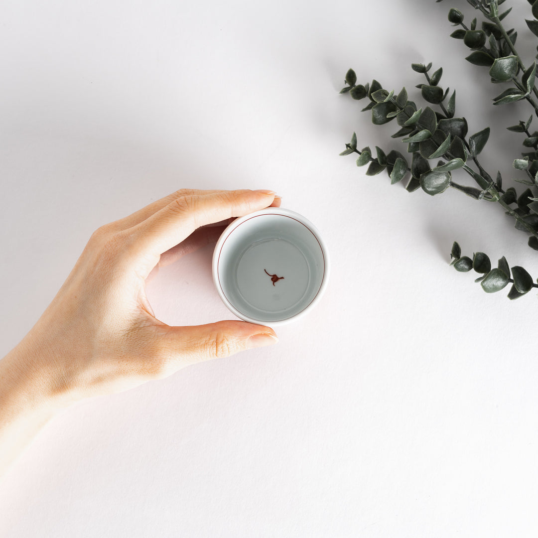 A small porcelain condiment bowl adorned with a blue floral pattern and soft brush strokes.