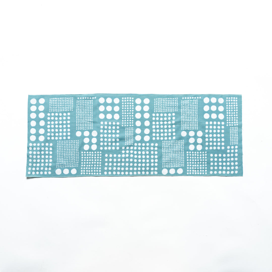 Blue polka dot tenugui hand towel laid flat, showing white dots in square arrangements.