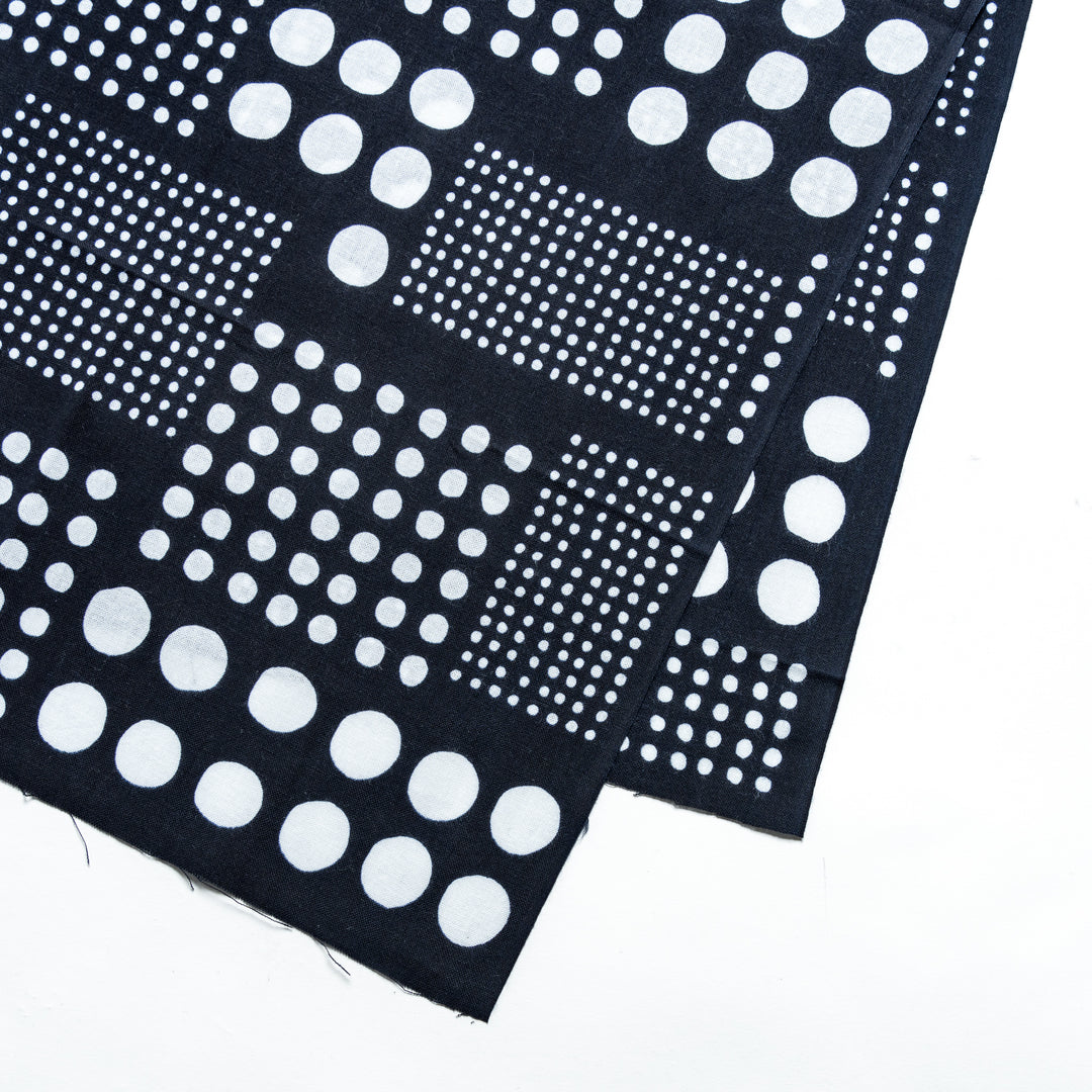 Close-up of navy blue tenugui hand towel highlighting its clean white polka dot design.