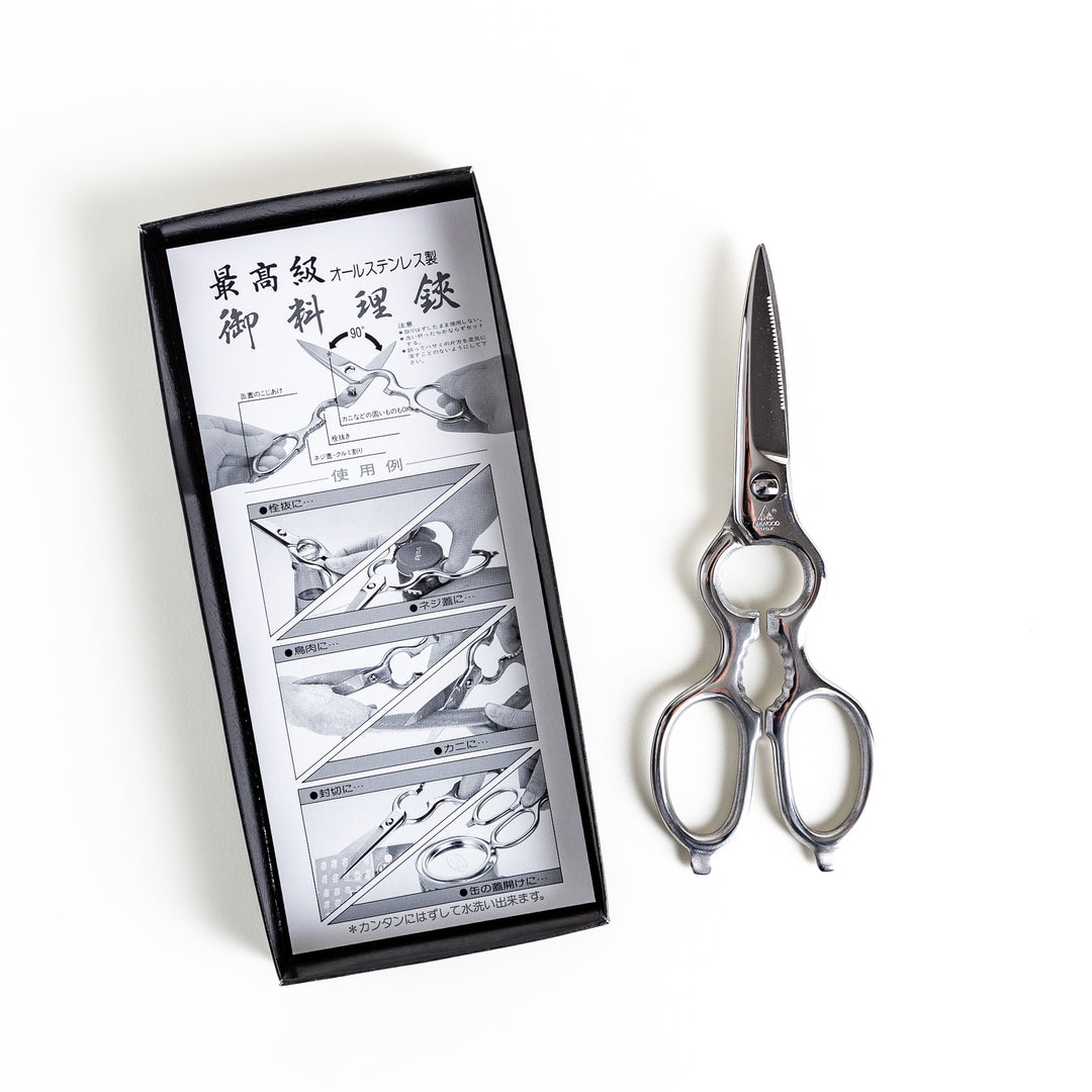 Premium Japanese pull-apart kitchen shears with instruction manual detailing usage and features, presented in a black box for clarity and style.