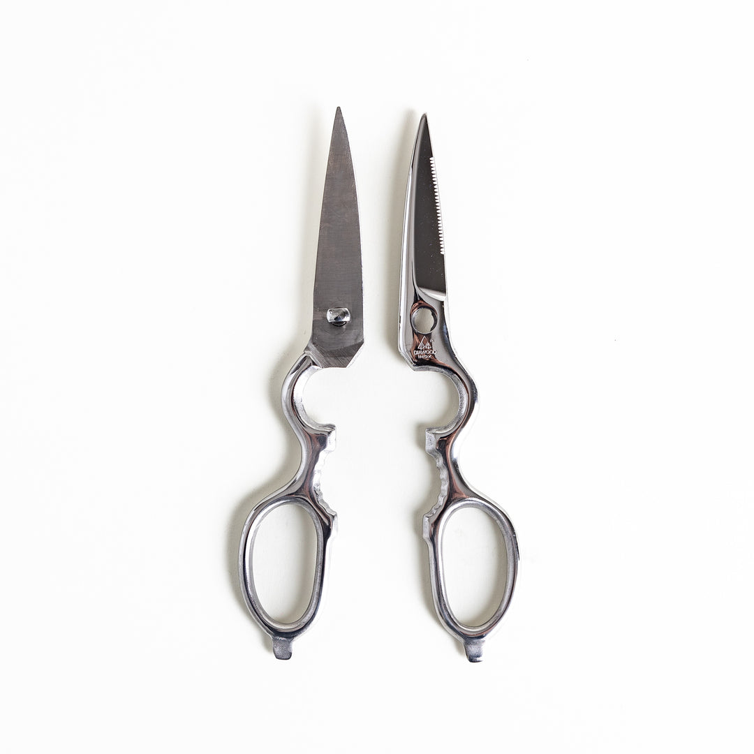 Premium Japanese pull-apart kitchen shears separated into two pieces, displaying the ergonomic handles and precision blades.