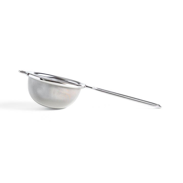 Stainless steel tea strainer with a fine mesh and a long handle, an essential kitchenware tool for brewing loose leaf tea.