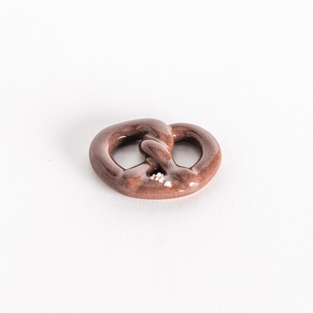 Angled view highlighting the pretzel’s rounded shape and details.