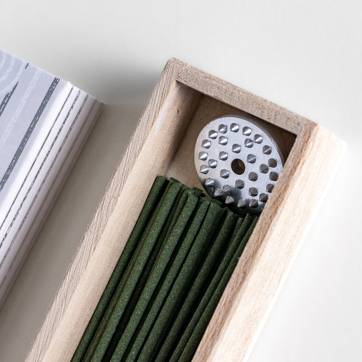 Purity White Sage Incense in a light wooden box with deep green sticks, elegantly packaged in a white design featuring subtle circular patterns, evoking a fresh and cleansing white sage aroma.