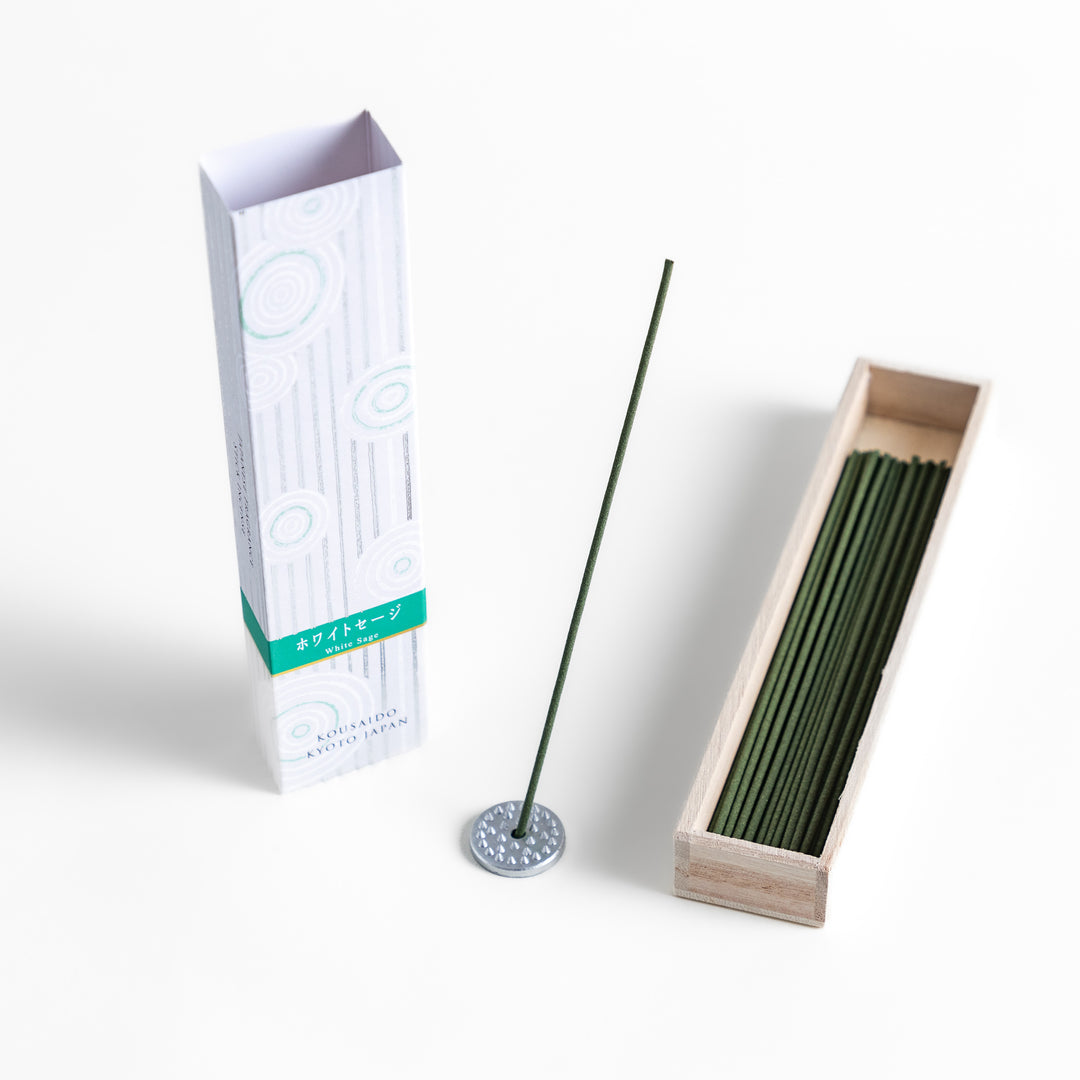 Purity White Sage Incense in a light wooden box with deep green sticks, elegantly packaged in a white design featuring subtle circular patterns, evoking a fresh and cleansing white sage aroma.