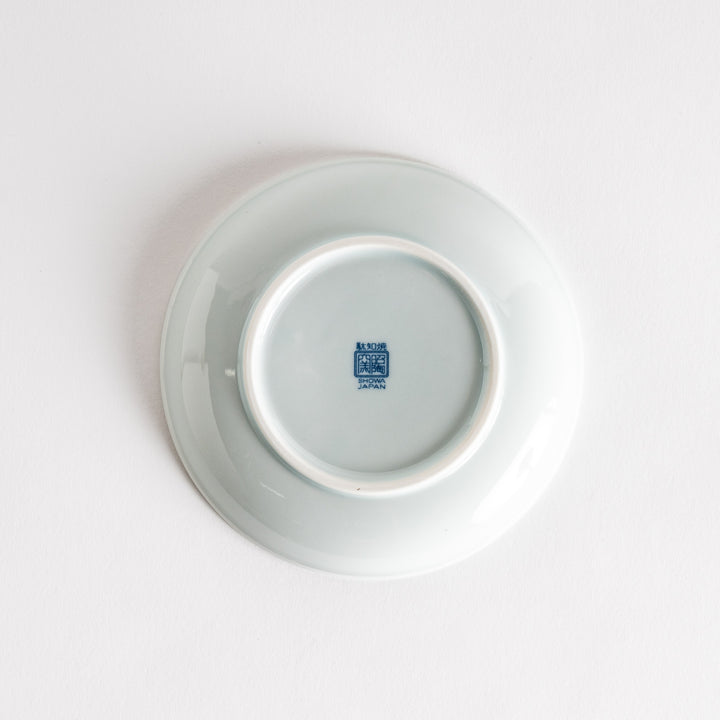 A dessert plate featuring blue waves and a rabbit motif on a white background.