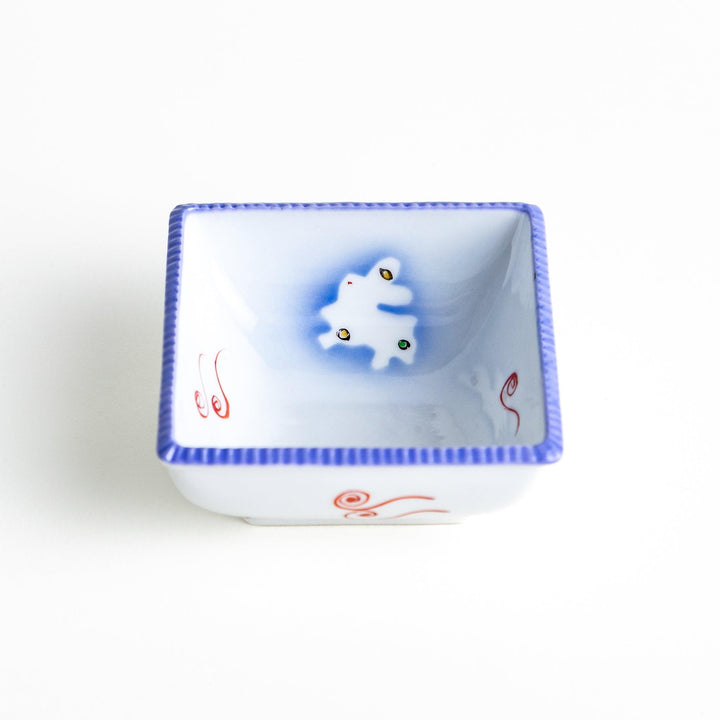 A square bowl featuring a rabbit and snowflake with a light blue rim.