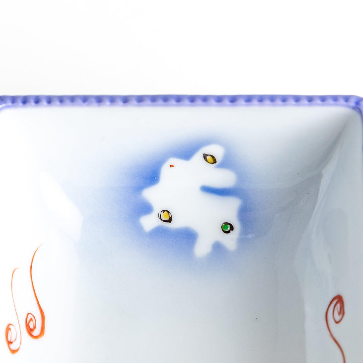 A square bowl featuring a rabbit and snowflake with a light blue rim.