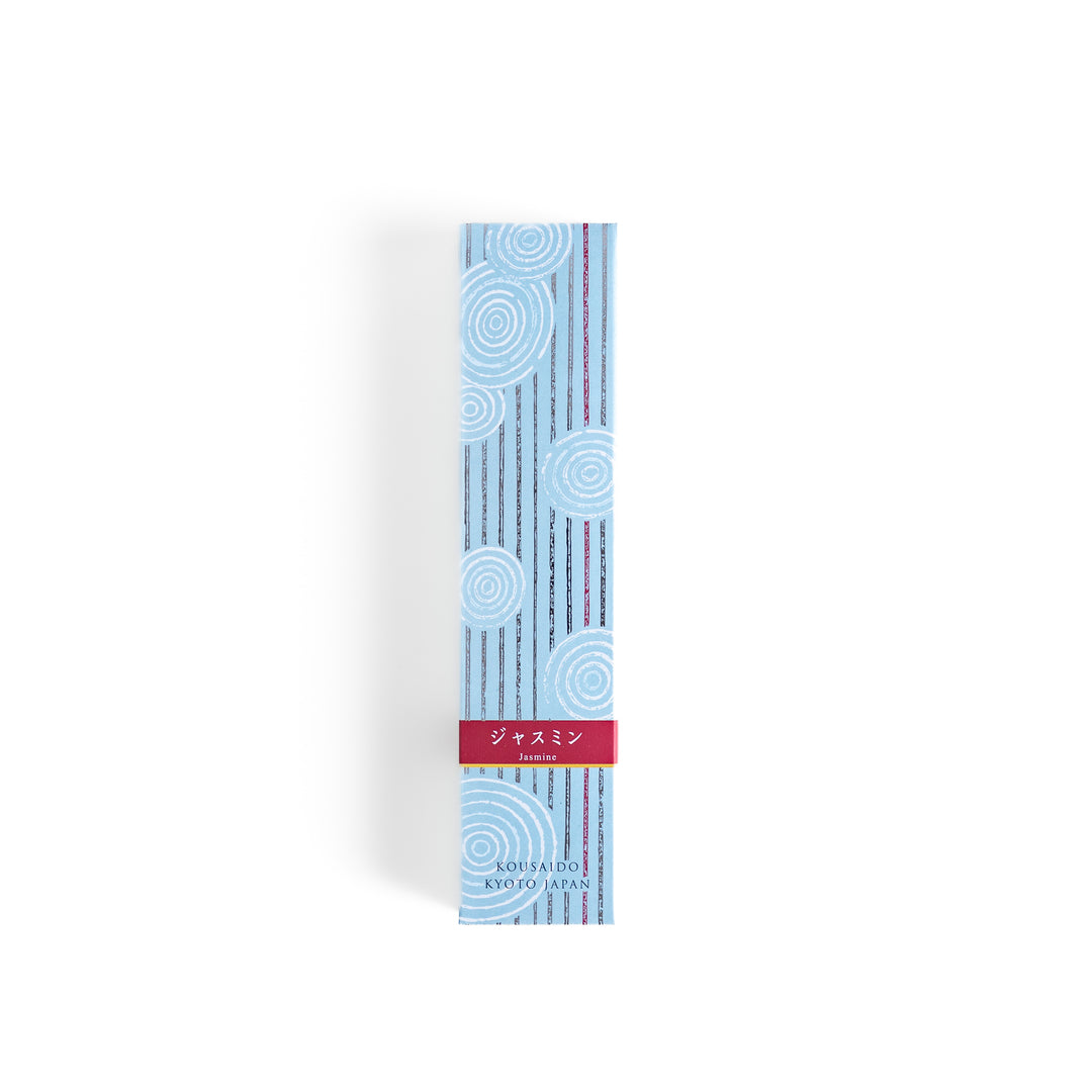 Radiant Jasmine Incense in a light wooden box with deep teal sticks, elegantly packaged in a soft blue design featuring white circular patterns for a fresh and floral ambiance.