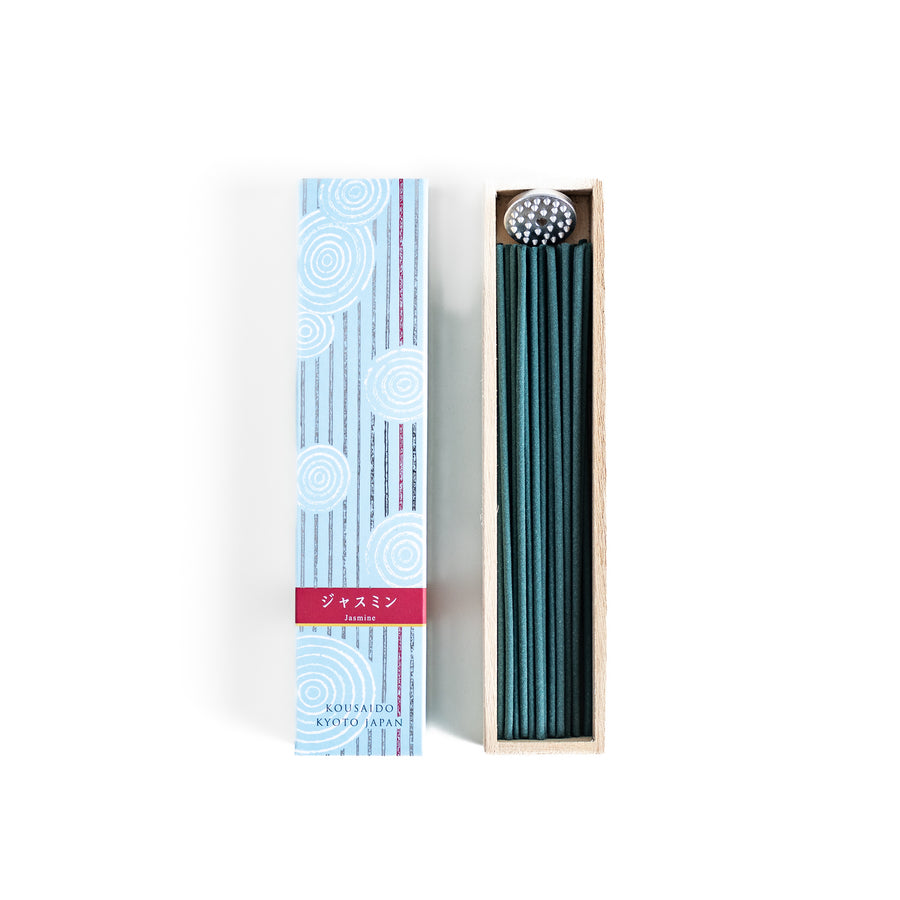 Radiant Jasmine Incense in a light wooden box with deep teal sticks, elegantly packaged in a soft blue design featuring white circular patterns for a fresh and floral ambiance.