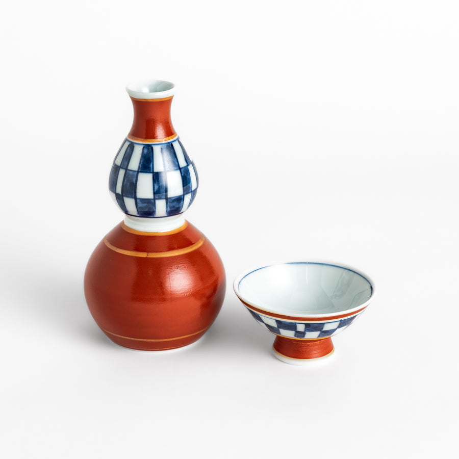 Elegant Japanese Sake Set featuring a red and white design with gold accents, perfect for enjoying your favorite sake.