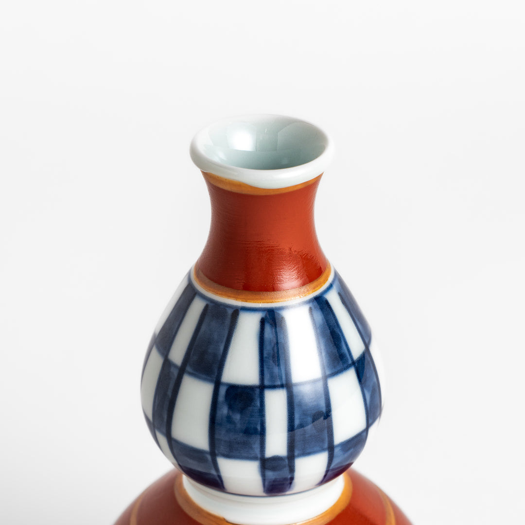 Elegant Japanese Sake Carafe featuring a red and white design with gold accents, perfect for serving your favorite sake. 